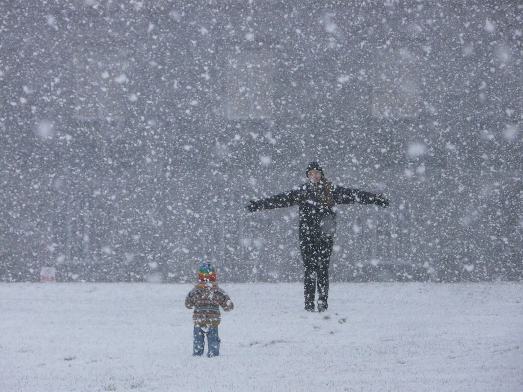 An infant enjoys his/hers first winter wonderland