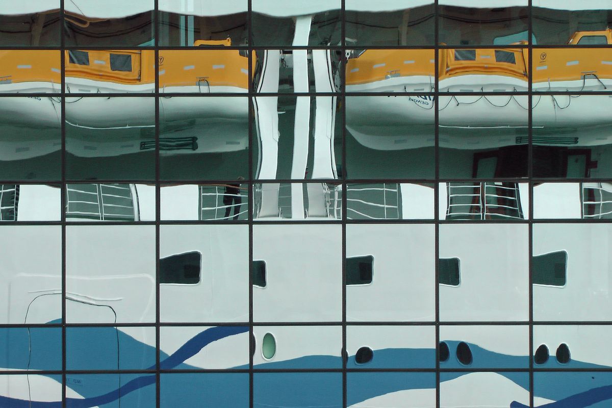 The German cruise ship Aida Luna is reflected in a glass facade. Watched in July 2010 in Reykjavik, Iceland.